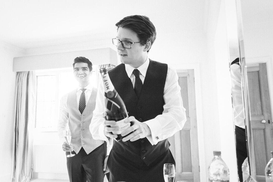 the best man pours the champagne