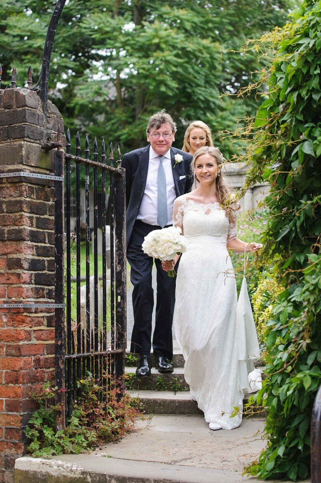 The beautiful bride arrives with her father at Holy Trinity Church Guildford