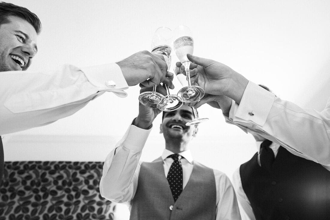 groomsmen cheer on the morning of the wedding