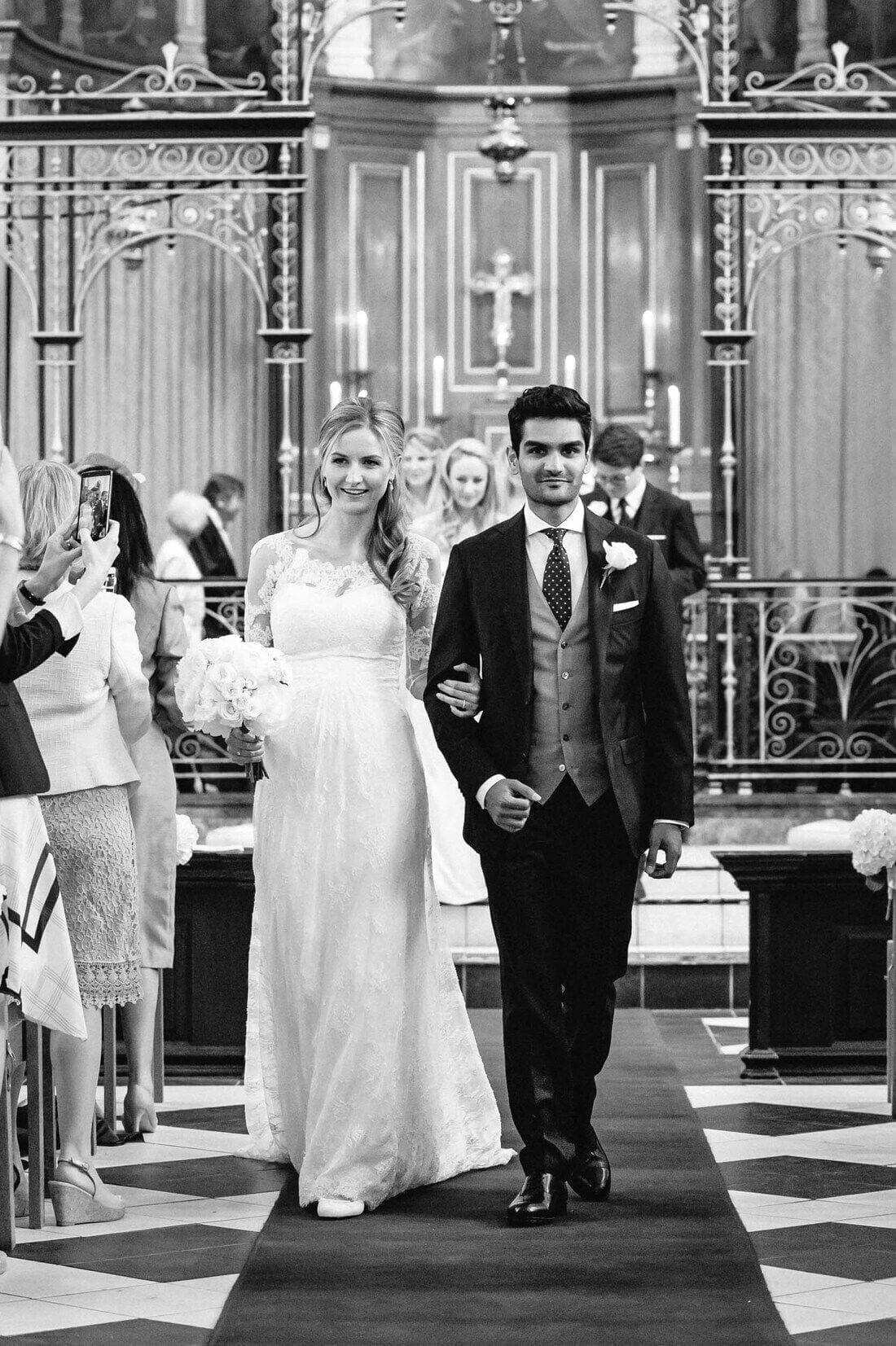 Sophie and Anish leave Holy Trinity Church Guildford after their wedding ceremony