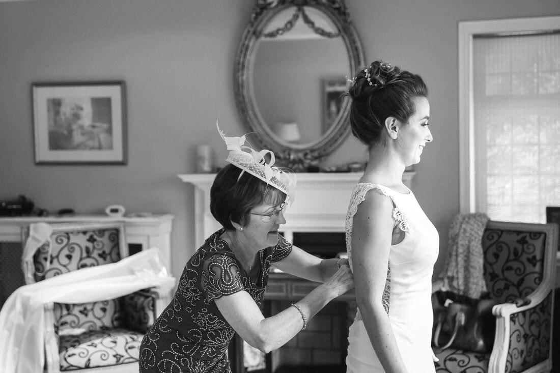 mum fixing her daughter's wedding dress