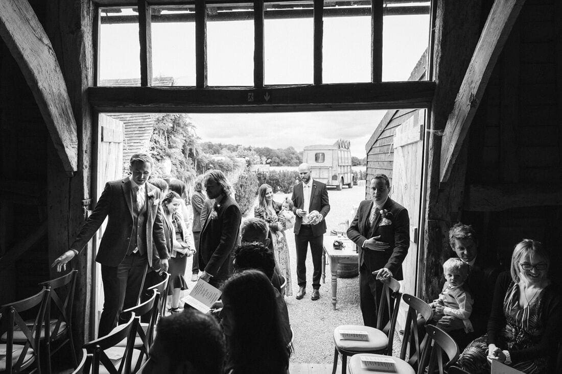 wedding guests are seated in the barn at high billinghurst farm