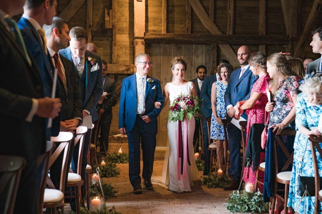 the father of the bride walks his daughter down the aisle 