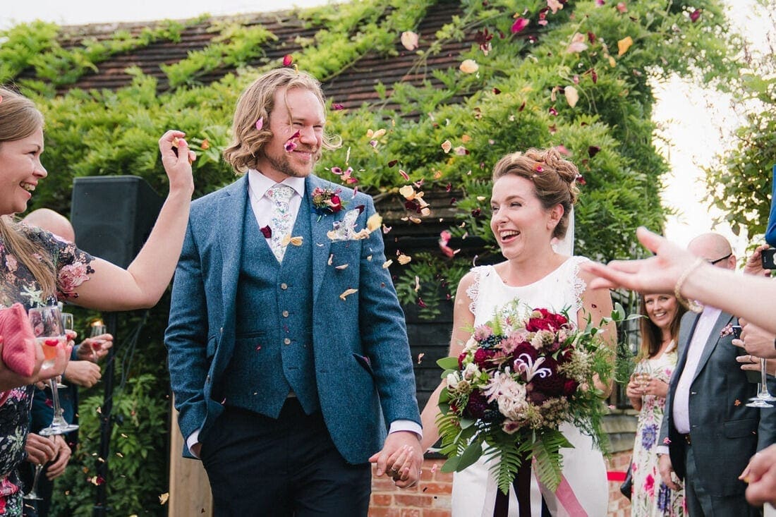 the married couple get showered in confetti