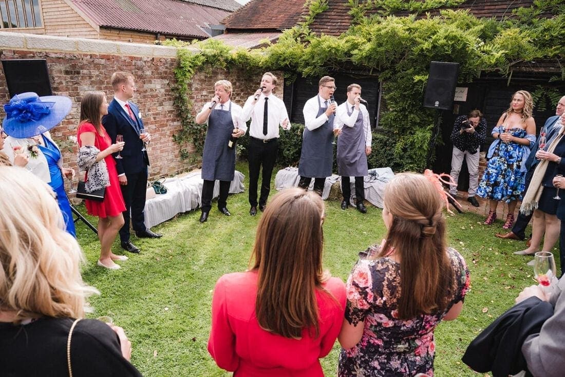 wedding guests are entertained by an a cappella singing group