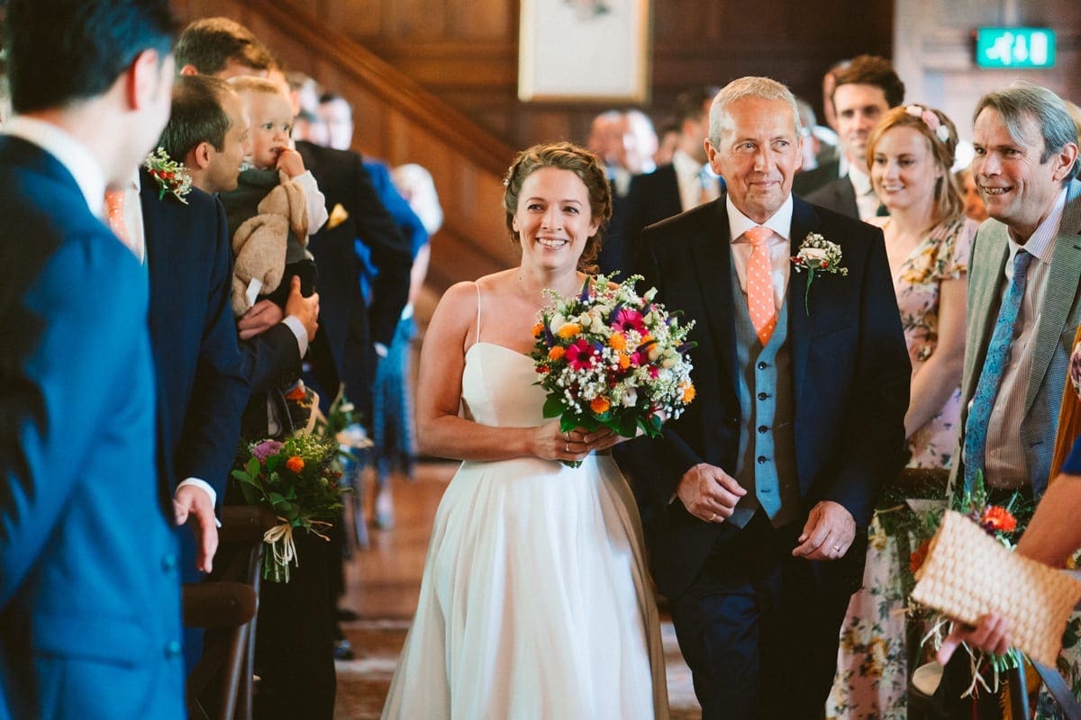 a moving moment as the bride enters the wedding ceremony with her father