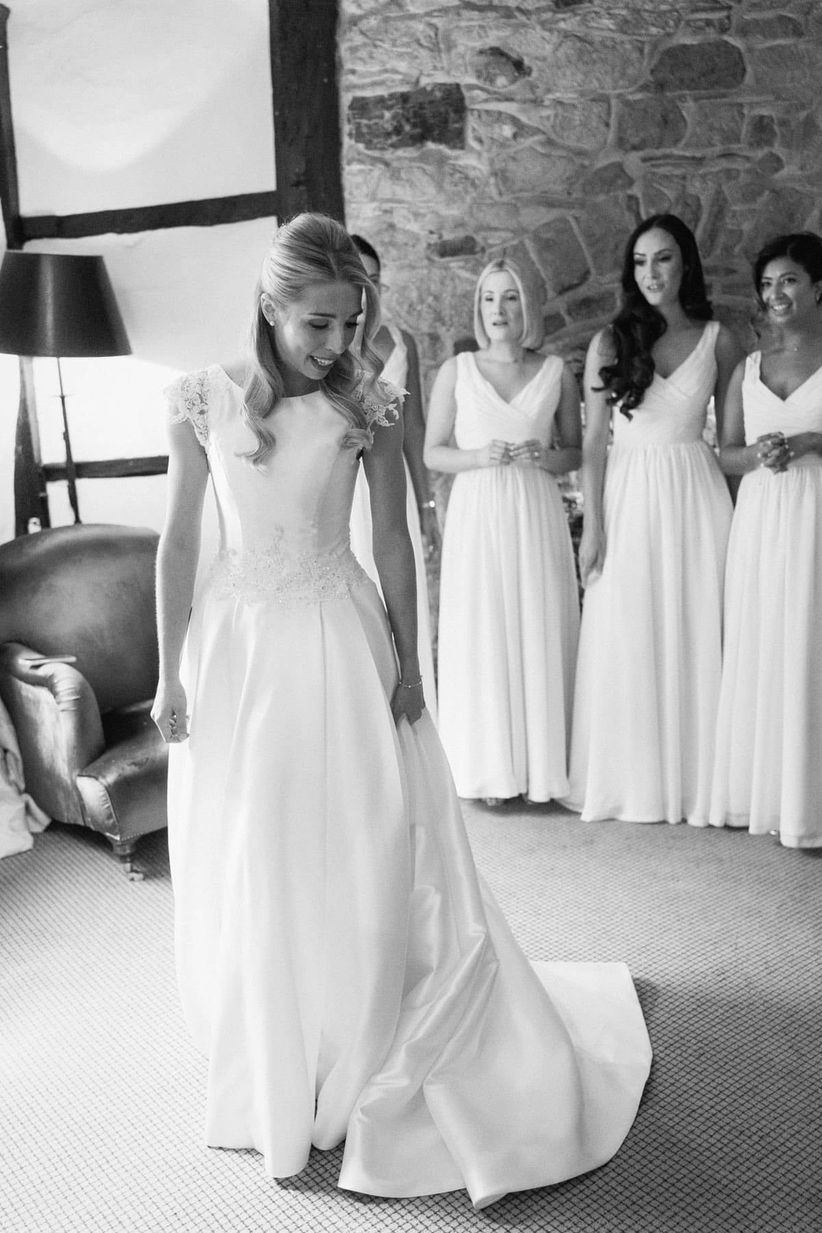 full length black and white photo of the bride in her wedding dress