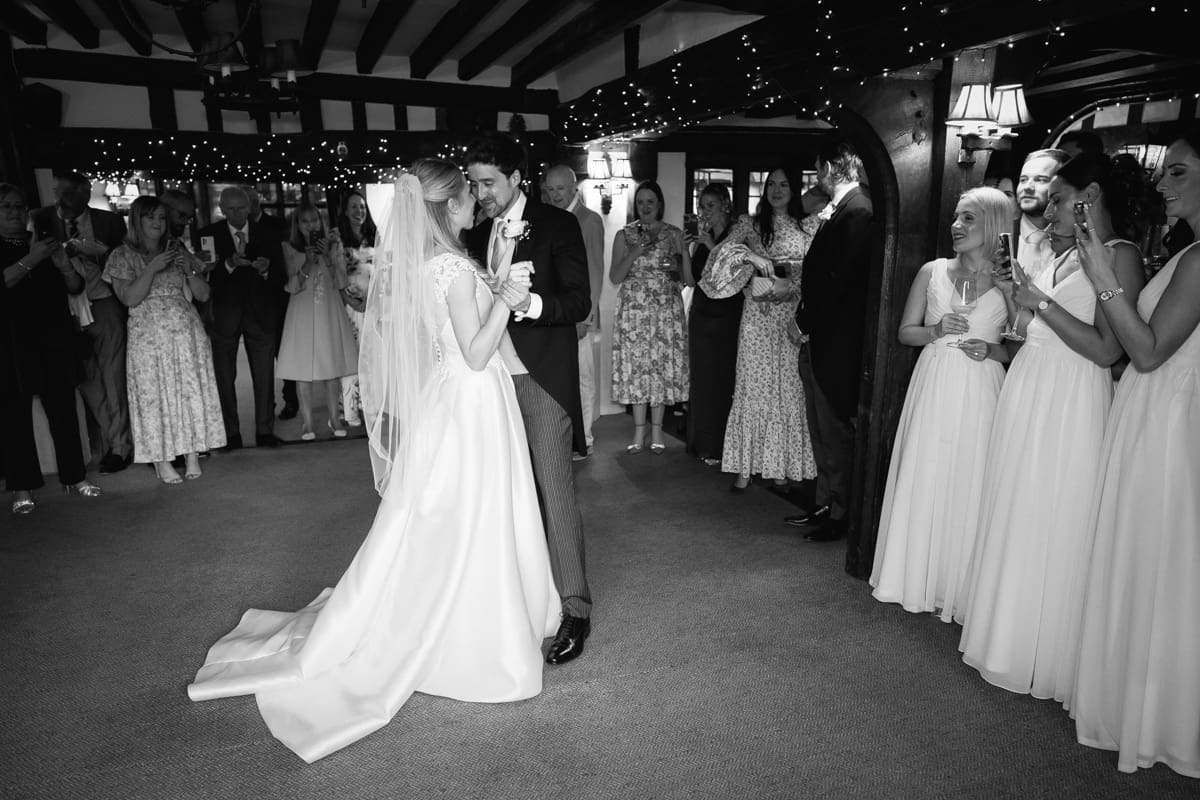 First dance surrounded by friends and family at their small pub wedding