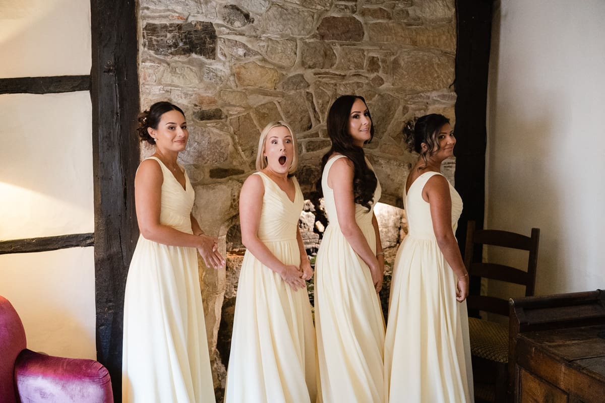 bridesmaids react to seeing the bride in her wedding dress for the first time