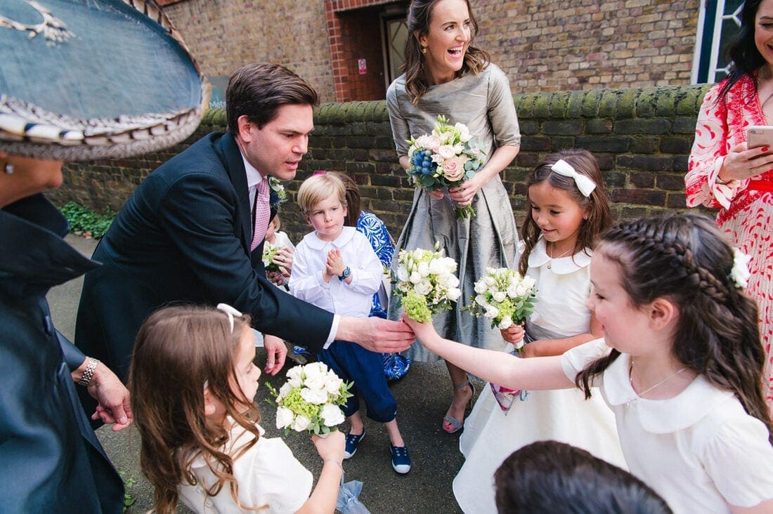 the bridal party gather outside church